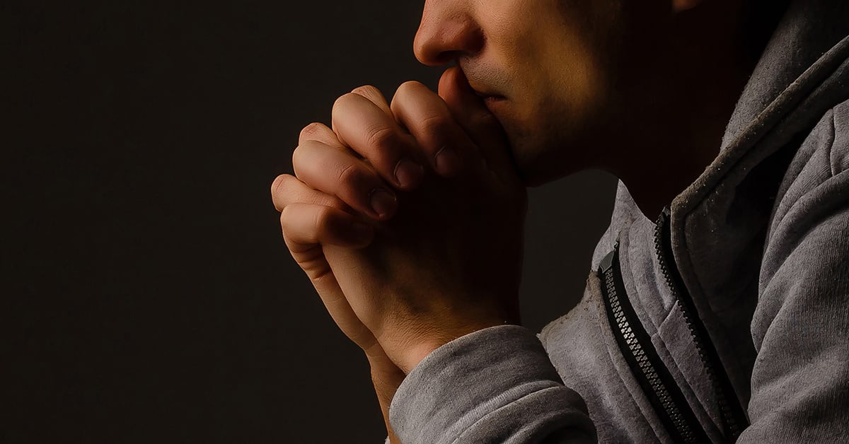 Young man praying | Wycliffe Associates | Bible translation