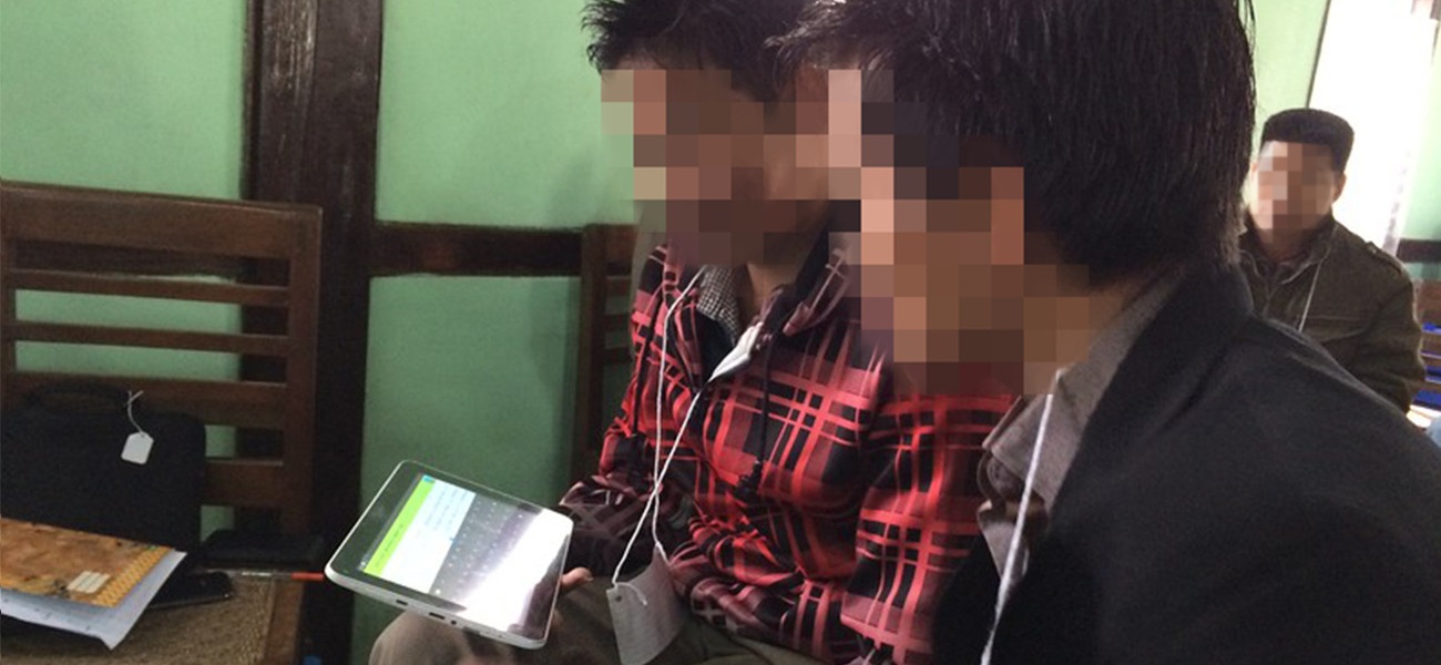 Bible translators using tablet