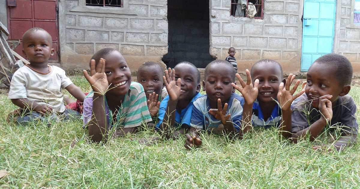 A group of children playing in the grass