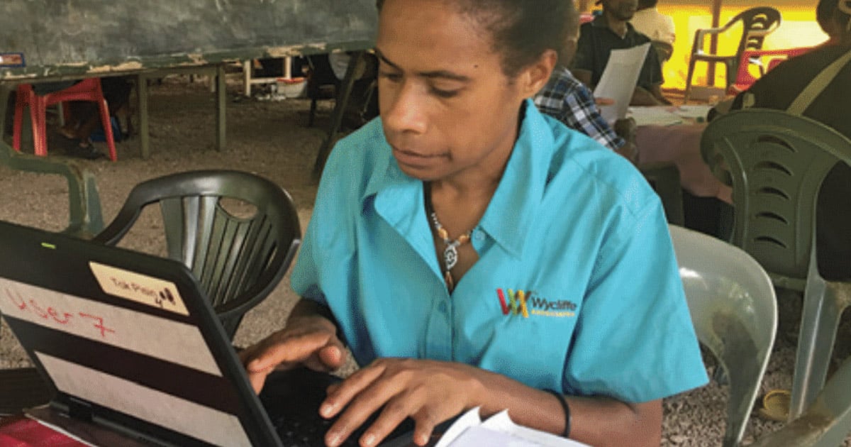 Dedicated translator Shilla working on a laptop Dedicated translator Shilla working on a laptop