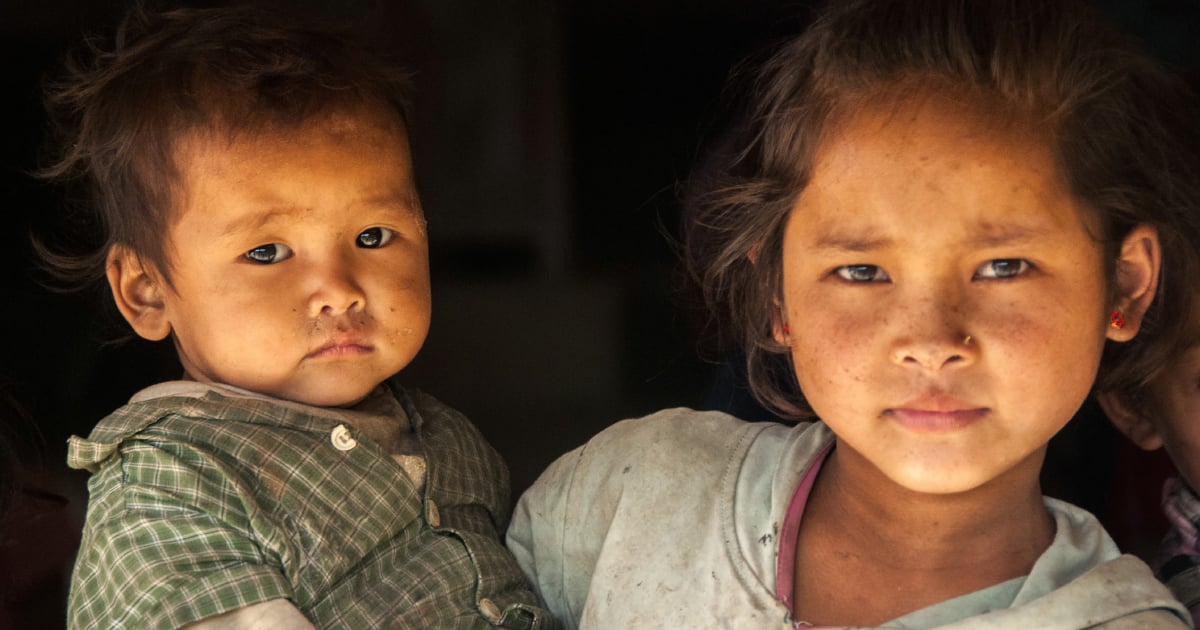 An Asian girl holding a small child