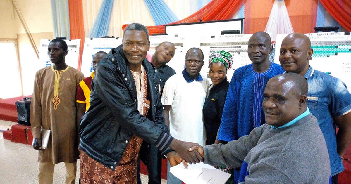 Bible translator teams shaking hands