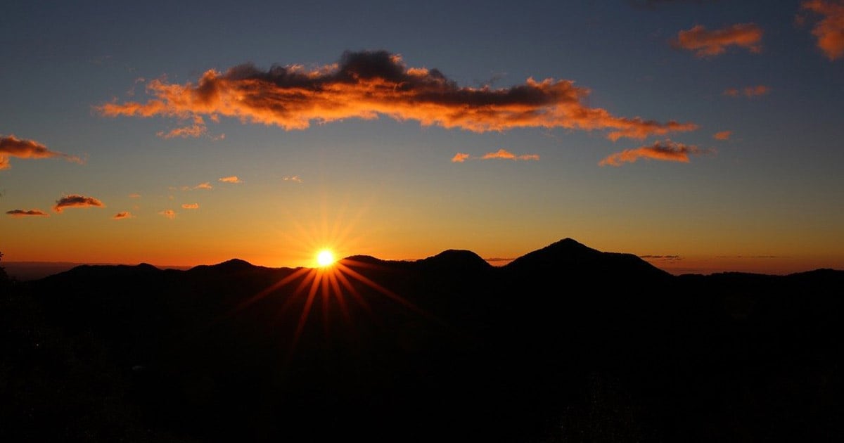 Sun peeking over hills