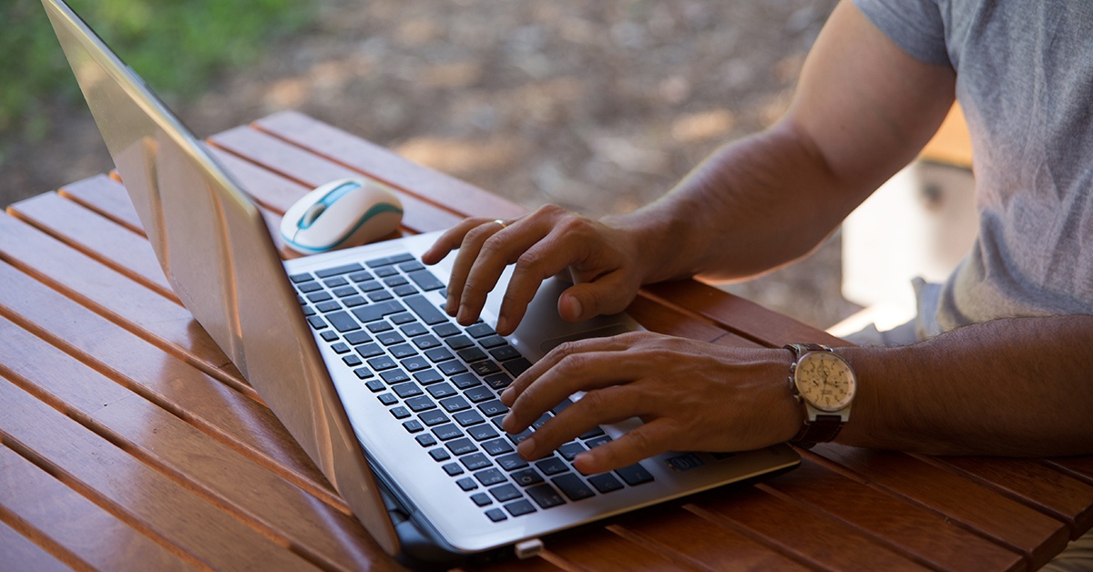 man work from home computer outside - 1200x628