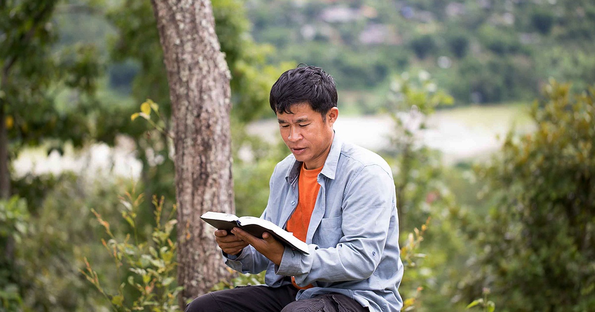 asian man reading bible | Wycliffe Associates | Advancing Bible Translation 