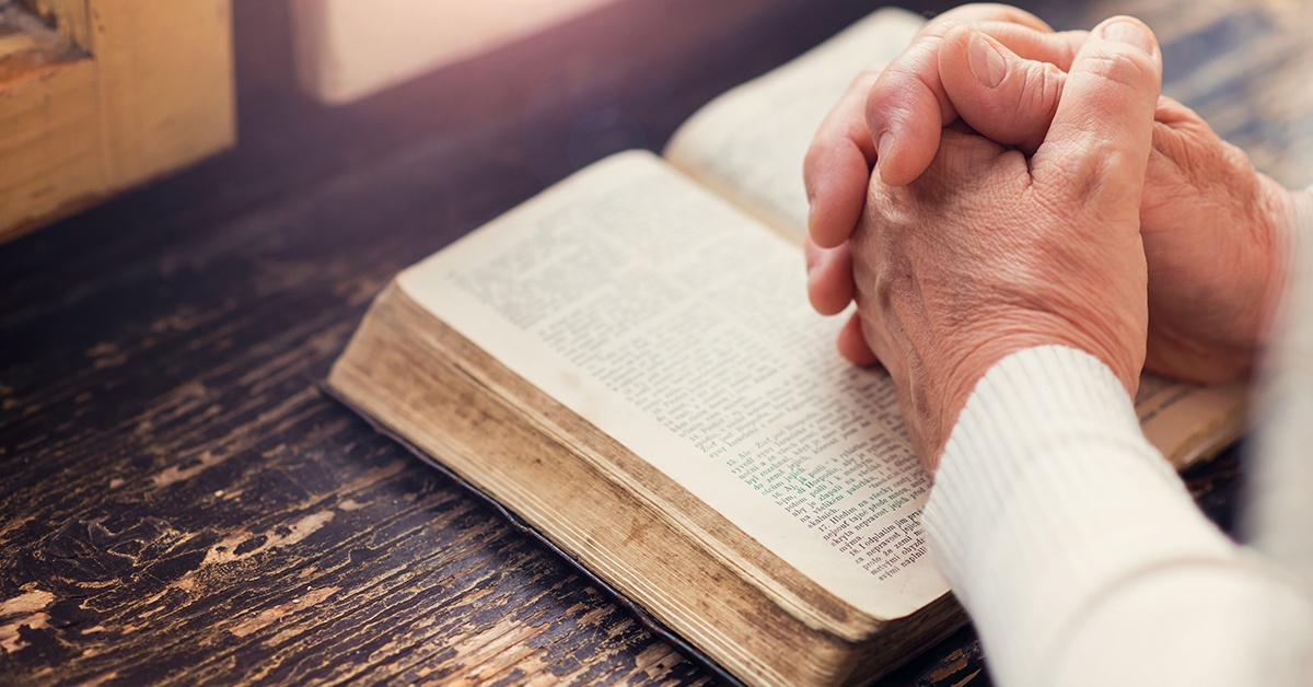 Woman praying with Bible in hands Woman praying with Bible in hands