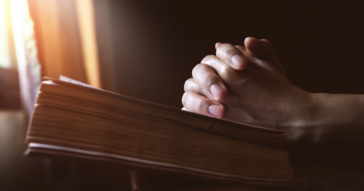 praying with bible | Wycliffe Associates | Advancing Bible Translation