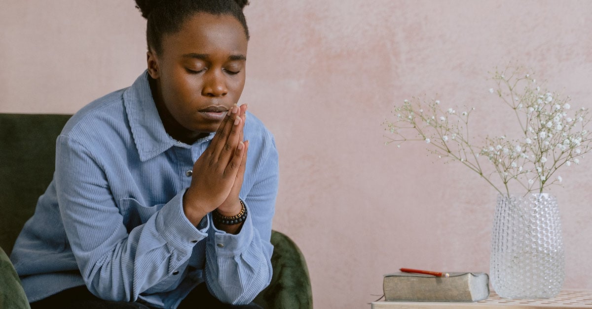 young woman praying at home | Wycliffe Associates | Advancing Bible Translation