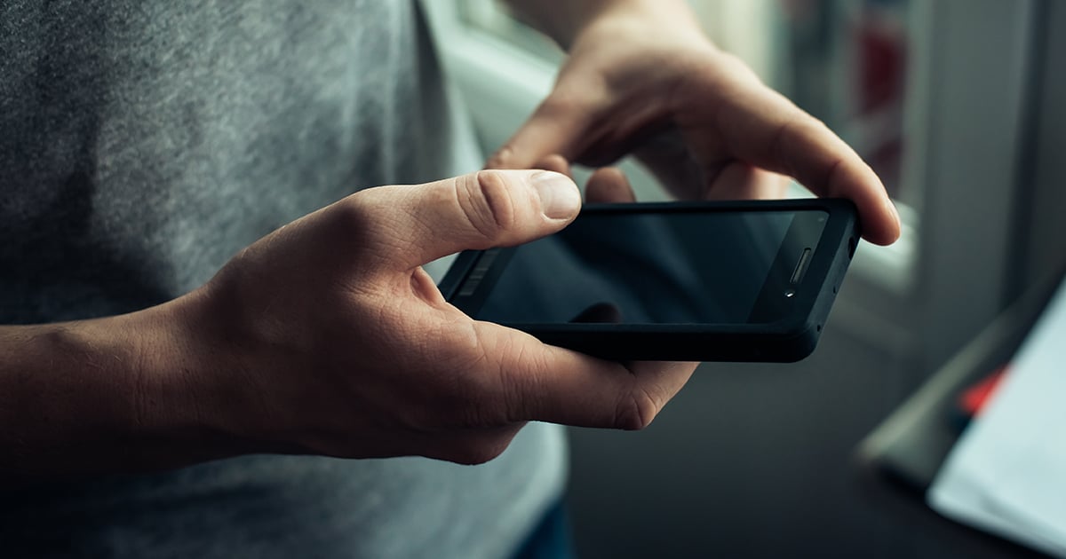 Man holding mobile phone Man holding mobile phone