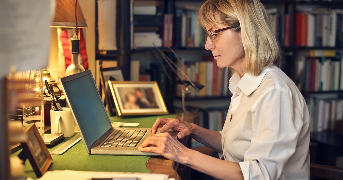 woman typing at computer desk