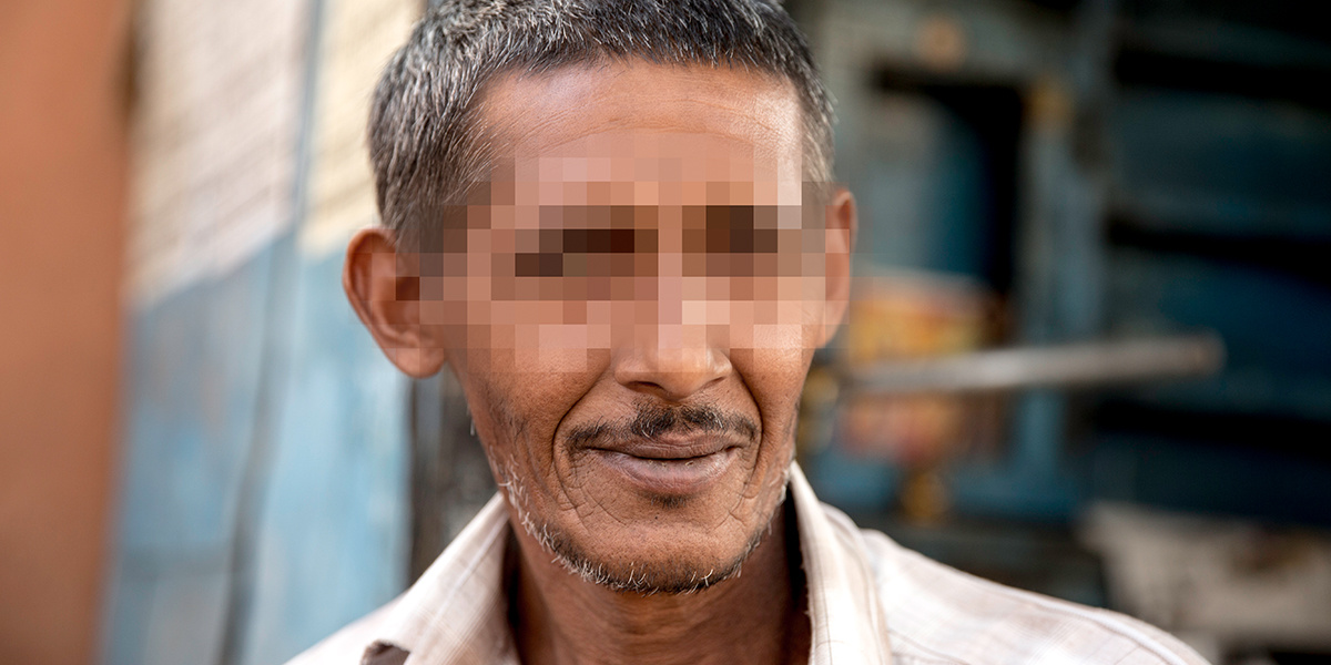 Southeast Asian man with is eyes blurred out for safety.