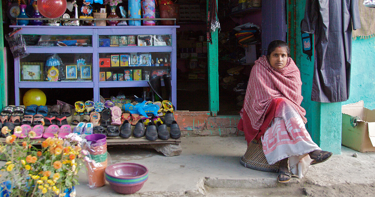 Woman Sitting on Side of Street