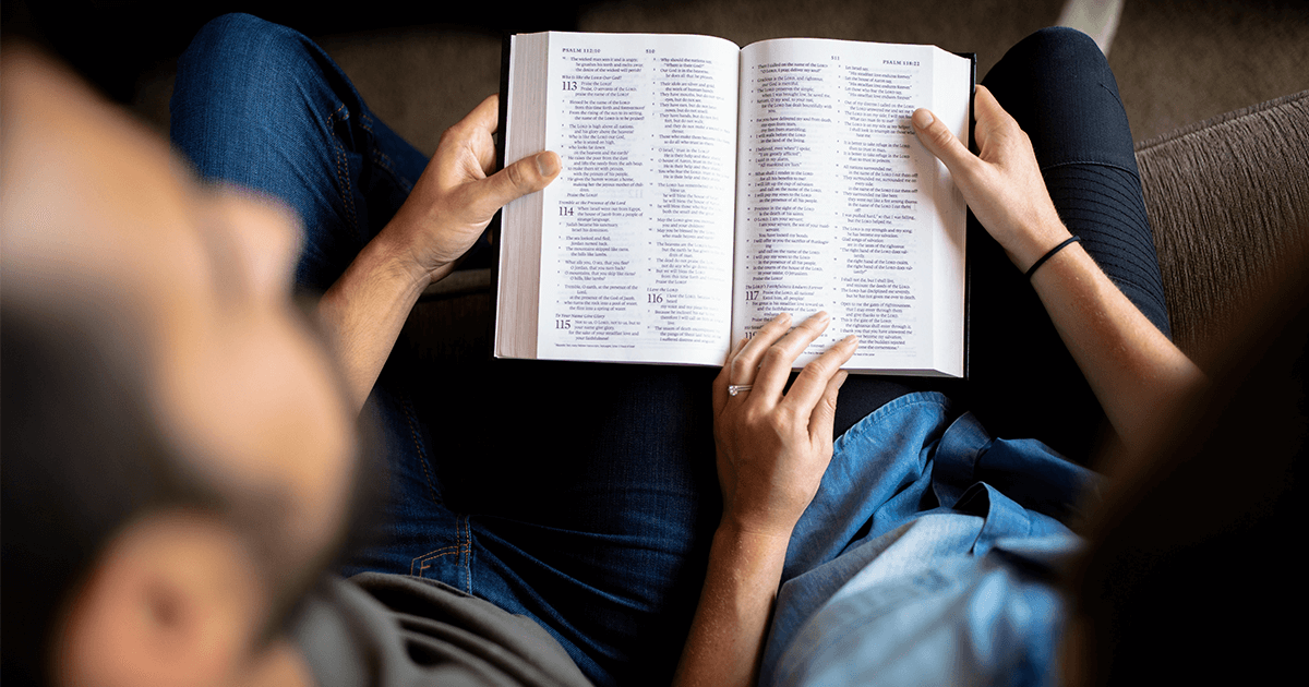 Couple Reading Bible on Couch