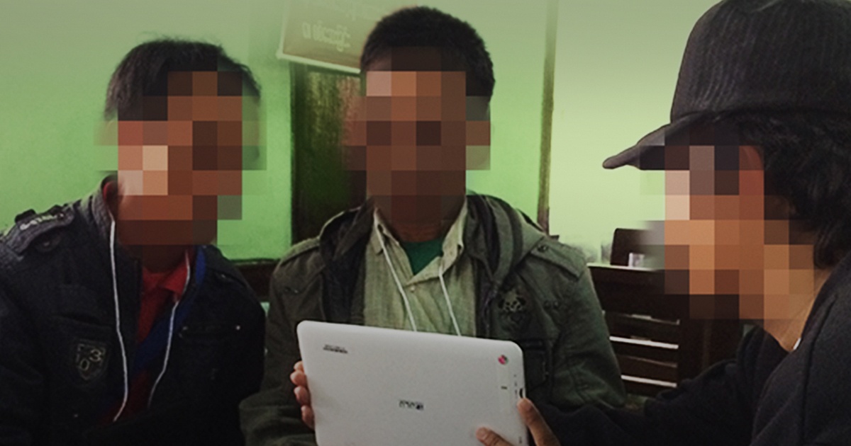 Three Bible translators using a tablet