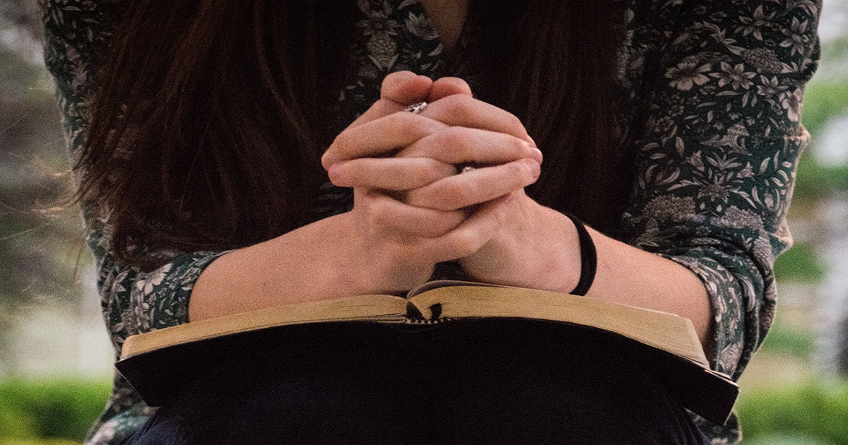 woman-pray-outside-bible-1200-Wycliffe-Associates-Bible Translation-Tablets